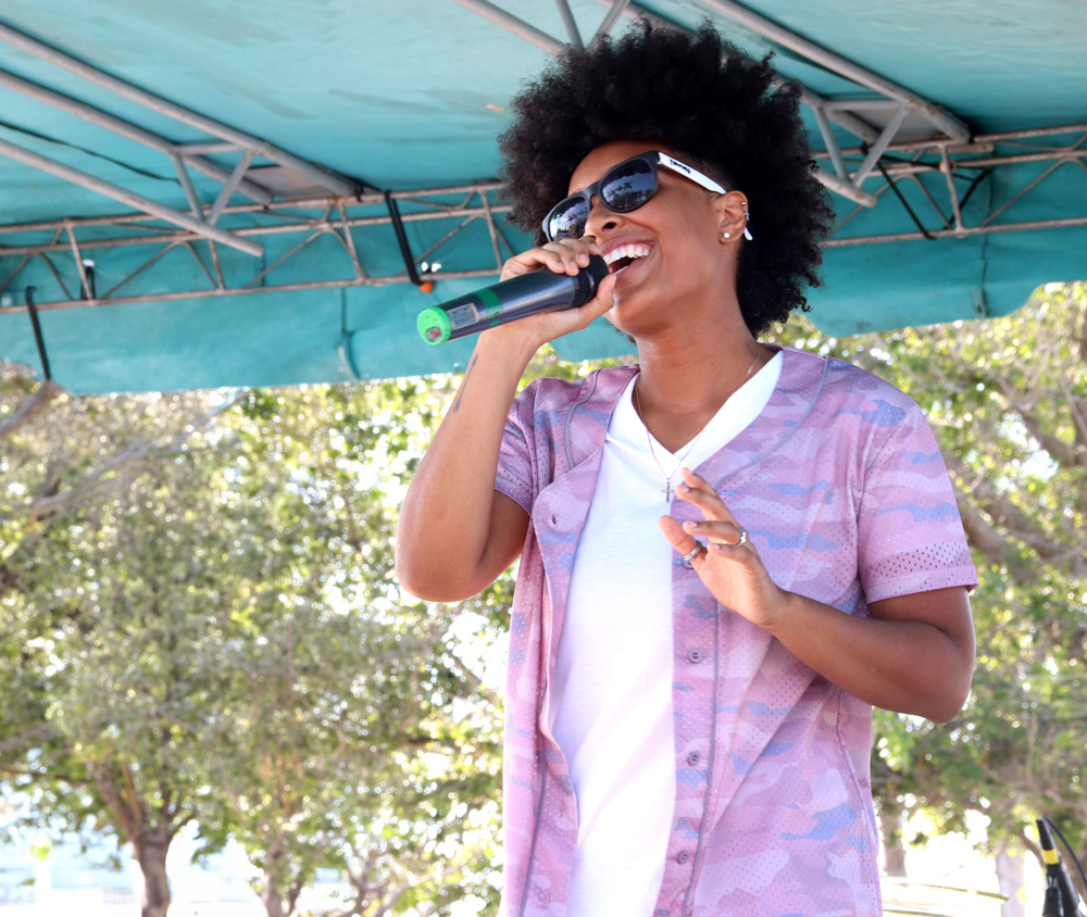 Woman in pink with sun glasses singing